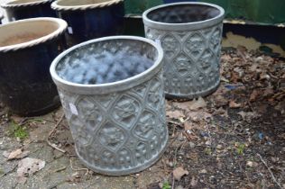A pair of faux lead circular planters.