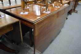 A George III mahogany drop-leaf dining table.