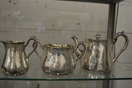 A silver three piece tea service.