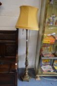 A heavy brass floor standing lamp.
