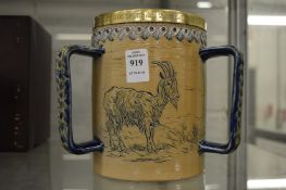 A Royal Doulton salt glazed tyg, incised decoration of goats by Barlow, the plated rim engraved
