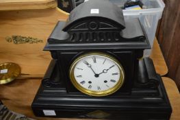 A large slate mantel clock.