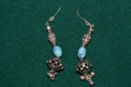 A pair of decorative earrings.