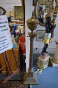 A large and impressive ornate brass corinthian column style floor standing oil lamp converted to