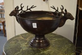 A pedestal bowl with stag head handles.