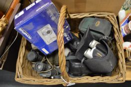 Various camera equipment and binoculars.