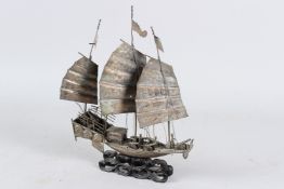 A LARGE CHINSE WHITE METAL MODEL OF A SHIP. 30cms high.