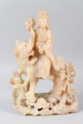 A LARGE CHINESE CARVED SOAPSTONE GROUP, 19TH/20TH CENTURY, modelled as Guanyin seated on the back of