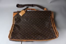 A LOUIS VUITTON SUIT BAG / HOLDALL. 55cms wide.
