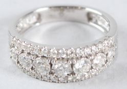 AN 18CT WHITE GOLD DIAMOND HALF HOOP RING, with pierced shank.