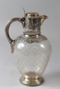 A GOOD 19TH CENTURY SILVER AND CUT GLASS CLARET JUG, with star cut glass body, silver mounts, handle