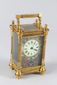 A LATE 19TH CENTURY FRENCH BRASS CARRIAGE CLOCK, with champleve enamel back plate, cream enamel dial