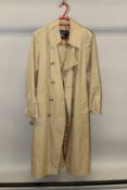 A BURBERRY TRENCH COAT.