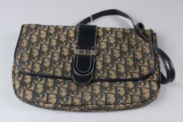 CHRISTIAN DIOR, A LADIES MONOGRAMMED CLOTH HANDBAG with black leather trim, with certificate.