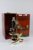 AN E. LEITZ WETZLAR, BRASS MICROSCOPE, in a mahogany case.