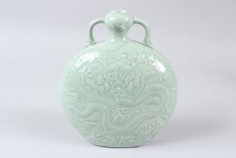 A FINE CHINESE CELADON CARVED DRAGON MOONFLASK. 22cms high.