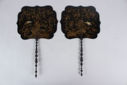A PAIR OF VICTORIAN BLACK LACQUER AND GILT DECORATED ORIENTALIST PAPIER MACHE HAND FANS. 39cms