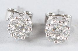 A PAIR OF 18CT WHITE GOLD DIAMOND CLUSTER EAR STUDS.
