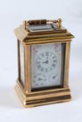 A MINIATURE BRASS MULTI-DIAL CARRIAGE CLOCK. 8cms high.