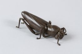 A JAPANESE BRONZE ARTICULATED DESERT LOCUST. 9cms.