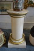 A CREAM PAINTED AND PARCEL GILDED CIRCULAR PEDESTAL, 20th Century, on a square base. 39cms