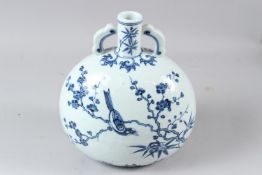 A CHINESE BLUE AND WHITE PORCELAIN MOON FLASK, painted with birds amongst a prunus tree. 26cms