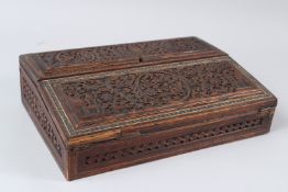 A 19TH CENTURY INDIAN CARVED SANDALWOOD WRITING SLOPE, with double hinged top opening to reveal a