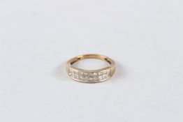 A 9CT GOLD CHANNEL SET BAND RING, 1.5 CARAT OF DIAMONDS.