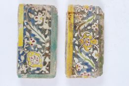 TWO 17TH - 18TH CENTURY PERSIAN SAFAVID BORDER TILES. 21cms x 11cms.