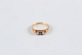 AN 18CT YELLOW GOLD, SAPPHIRE AND DIAMOND THREE STONE RING.