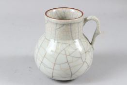 A CHINESE CRACKLE GLAZED PORCELAIN JUG, with loop handle. 13cms high.