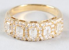 AN 18CT YELLOW GOLD RING, set with emerald cut and brilliant cut diamonds.