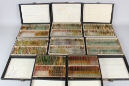 A GROUP OF EIGHT LEATHERCLOTH BOUND BOXES CONTAINING A QUANTITY OF MICROSCOPE SLIDES.