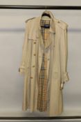 A BURBERRY TRENCH COAT.