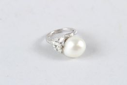 A 14CT WHITE GOLD ART DECO RING with large natural pearl, in diamond setting.