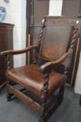 AN 18TH CENTURY OAK OPEN ARMCHAIR, with carved cresting rail, barley twist uprights, curving arms,