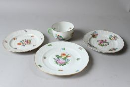 A HEREND PORCELAIN TEA CUP, TWO SMALL PLATES AND A SIDE PLATE, all painted with flowers. Plates: