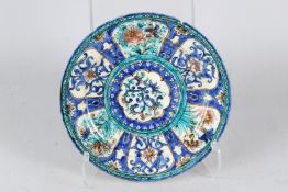 A FINE 19TH CENTURY PERSIAN QAJAR GLAZED POTTERY DISH. 28cms diameter.