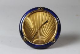 CARTIER, A CIRCULAR ART DECO STYLE DESK OR BEDSIDE STRUT CLOCK, with blue enamel frame and gilt