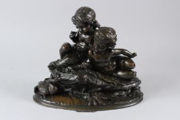 A GOOD 19TH CENTURY BRONZE GROUP, modelled as a boy and a girl seated by the water's edge, feeding a