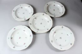 FIVE HEREND PORCELAIN BOWLS, painted all over with flowers. 25cms diameter.