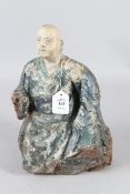 An 18th CENTURY CAVED AND POLYCHROME DECORATED SEATED BUDDHA. 30cms high.