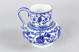A 19TH-20TH CENTURY TURKISH IZNIK STYLE GLAZED POTTERY JUG. 15cms high.