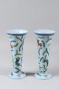 A PAIR OF HEREND PORCELAIN TRUMPET SHAPED VASES, pale blue ground, painted with fish and seaweed.