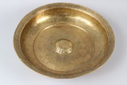 A LARGE GILT COPPER TOMBAK HAMMAM WASH BASIN, engraved with fish and stylised decoration. 46cms