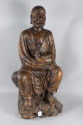 A LARGE CARVED WOOD FIGURE OF LUOHAN, also known as 