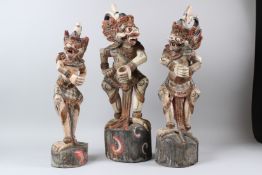 A SET OF THREE 19TH CENTURY INDONESIAN CARVED WOODEN KERIS DAGGER HOLDERS in the form of mythical