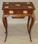 A 19TH CENTURY FRENCH KINGWOOD WORK TABLE, with oval porcelain panel and ormolu mounts, the rising