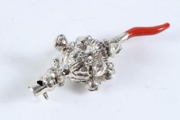 A CHILD'S SILVER AND CORAL RATTLE.