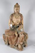 A LARGE CHINESE CARVED AND PAINTED WOODEN FIGURE OF GUANYIN seated in a posture known as 